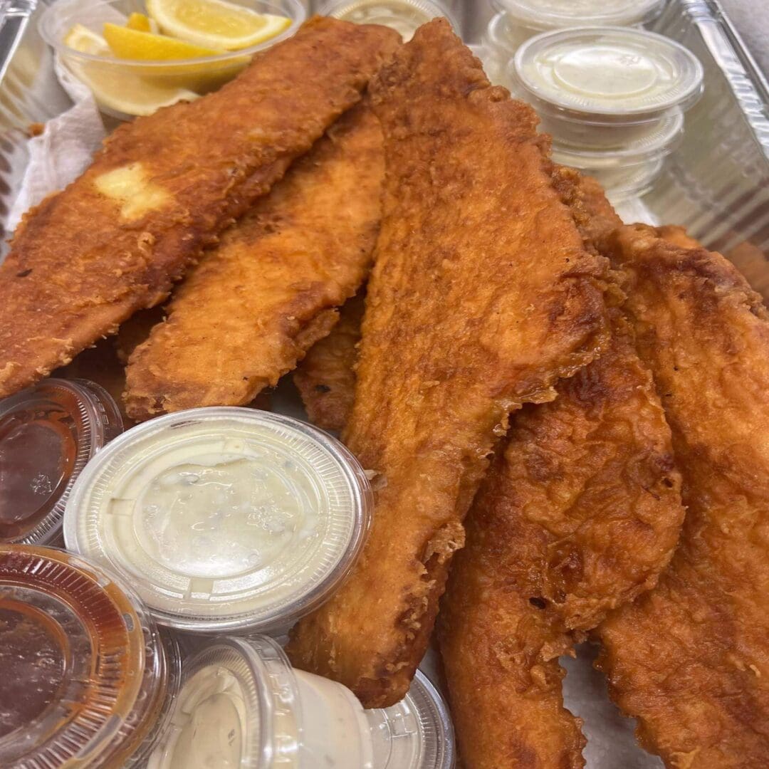 A tray of fish sticks and condiments